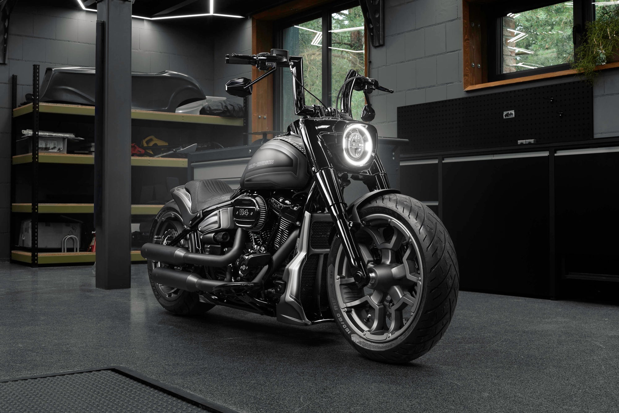 Harley Davidson Fat Boy motorcycle with Killer Custom parts from the front in a modern bike shop