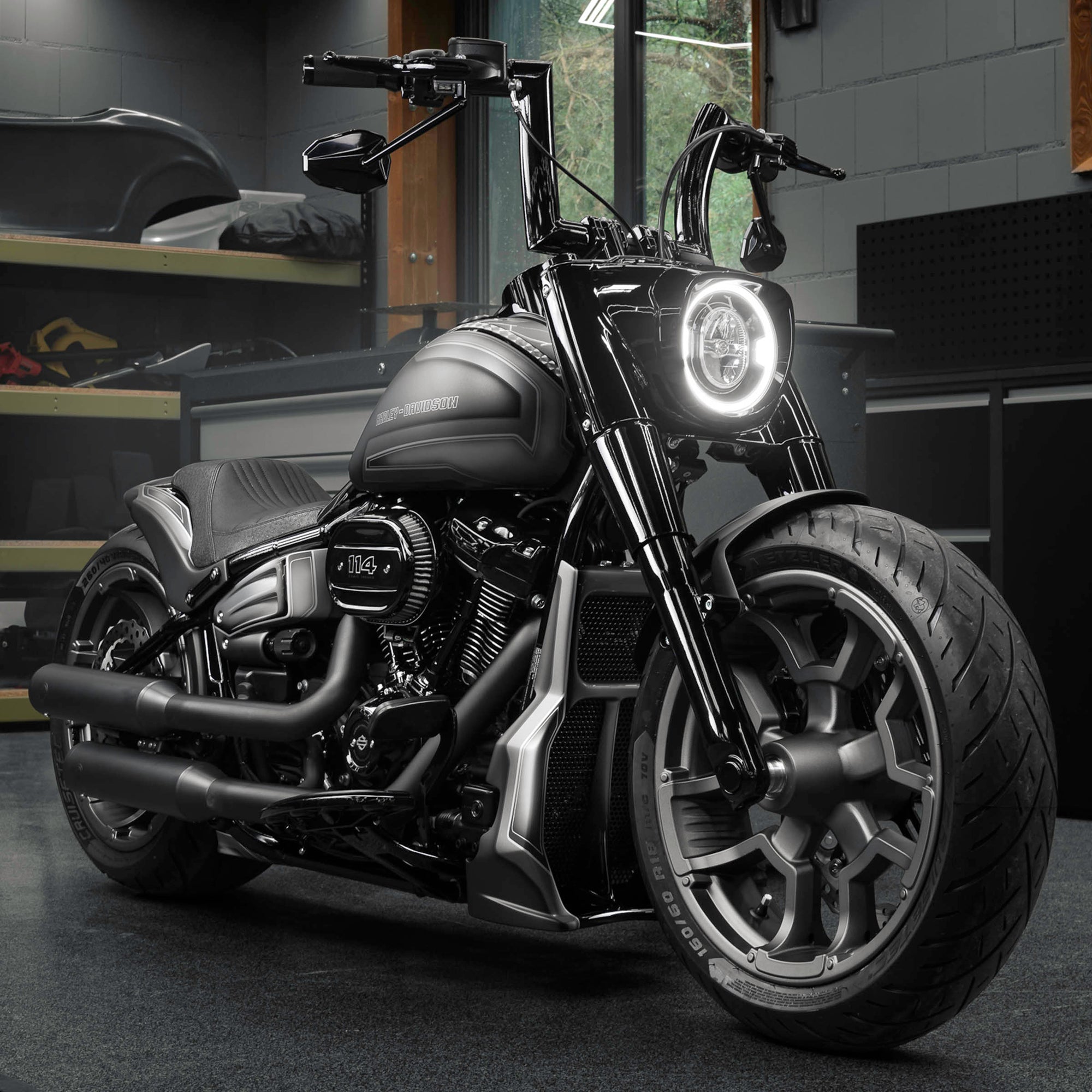 Zoomed Harley Davidson Fat Boy motorcycle with Killer Custom parts from the front in a modern bike shop