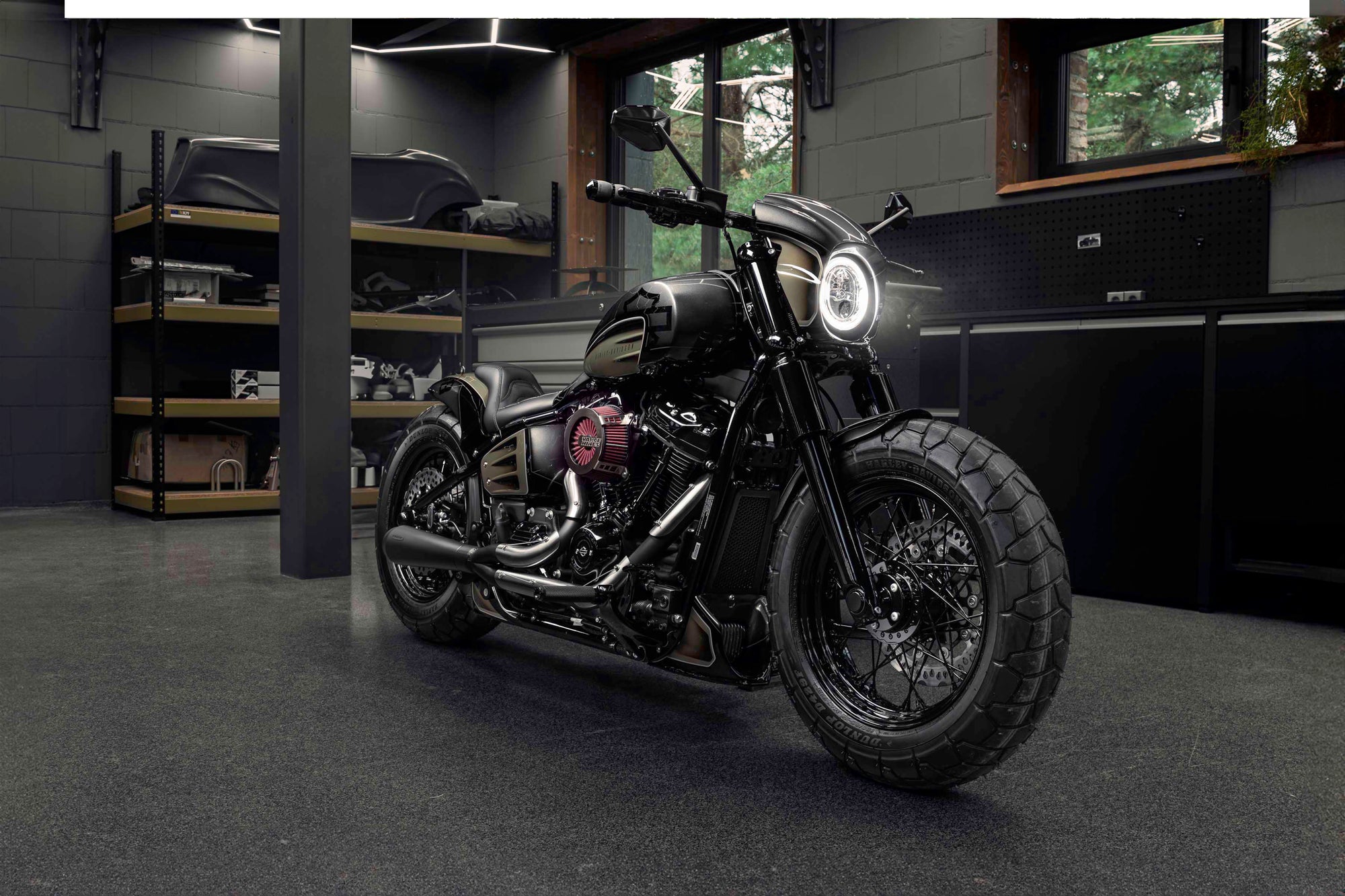 Harley Davidson motorcycle with Killer Custom parts from the front in a modern bike shop