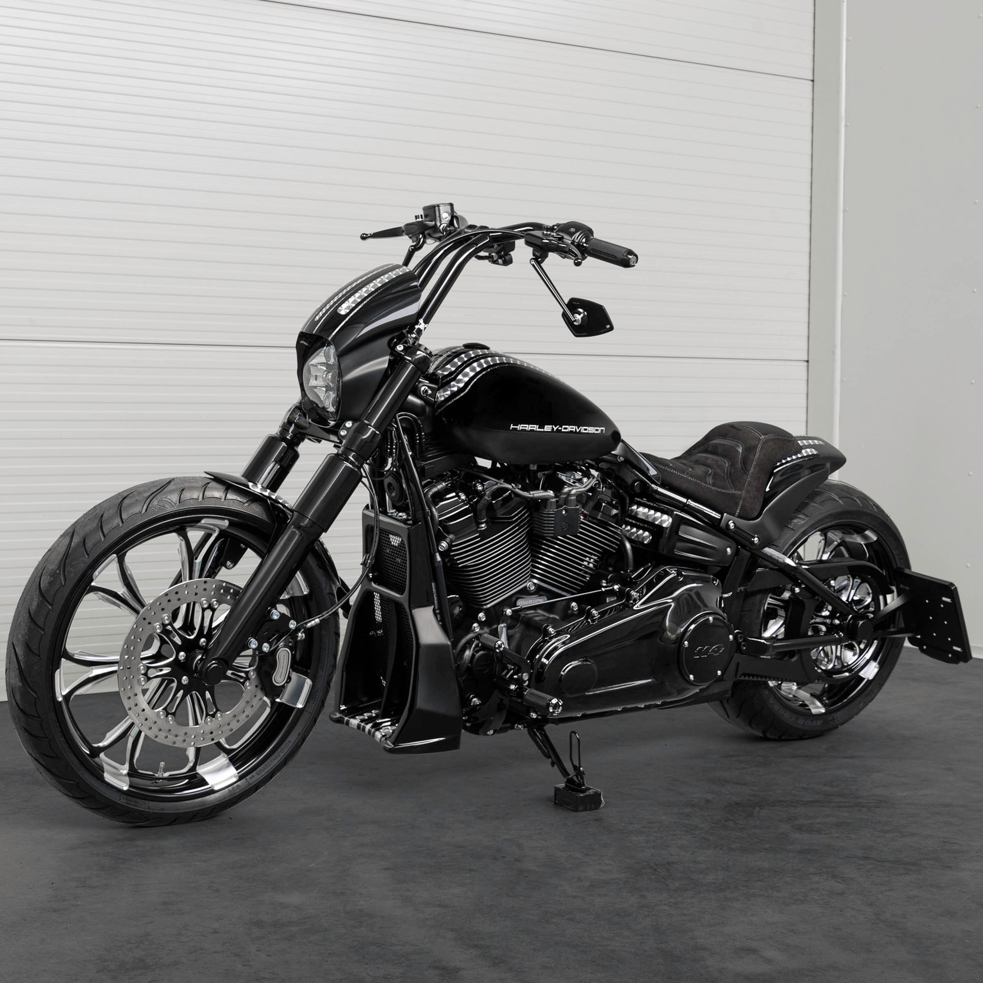 Harley Davidson motorcycle with Killer Custom parts from the side in a white modern bike shop