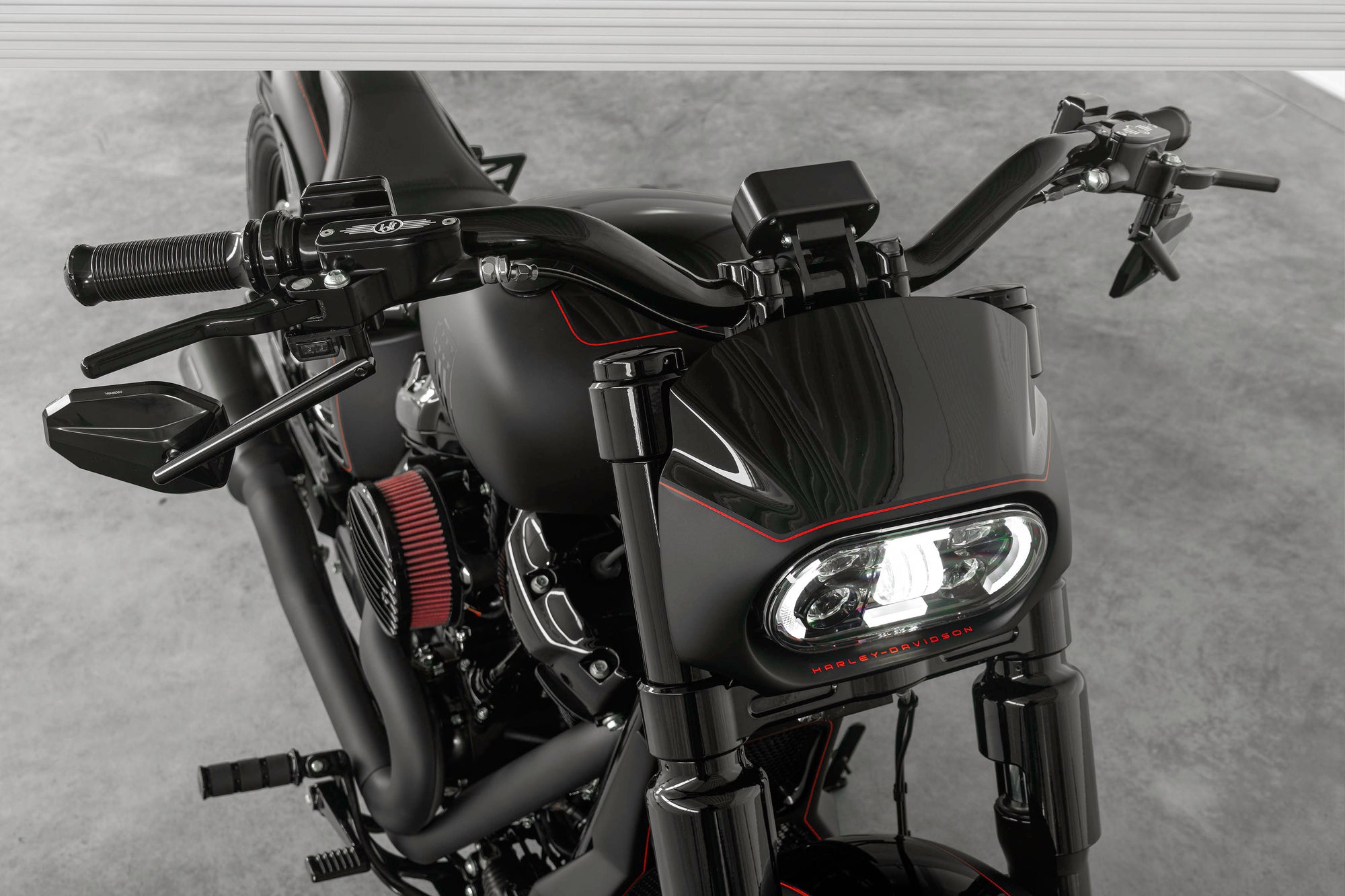 Zoomed Harley Davidson motorcycle with Killer Custom parts from above grey background