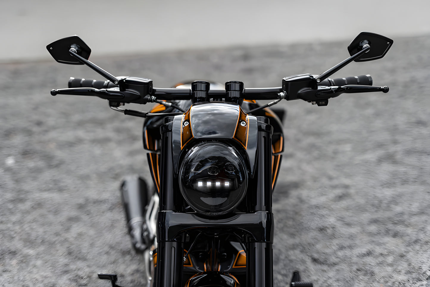 Harley Davidson motorcycle with Killer Custom black LED headlight kit V-Rod from the front blurry background