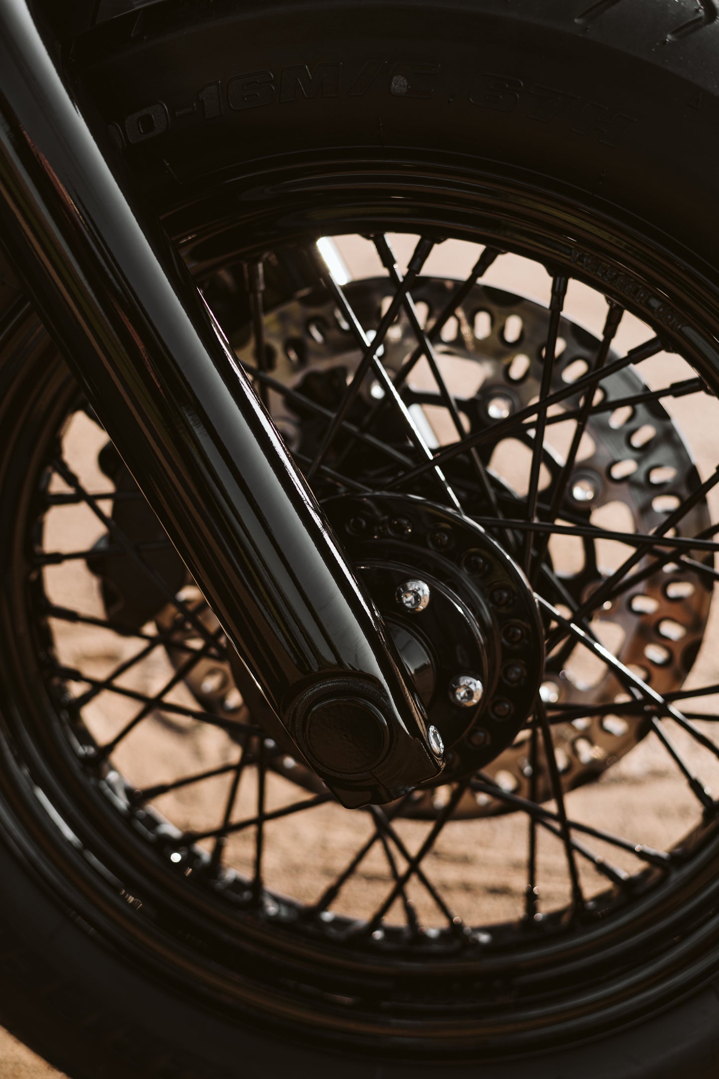 Zoomed Harley Davidson motorcycle with Killer Custom front wheel spacer kit blurry background