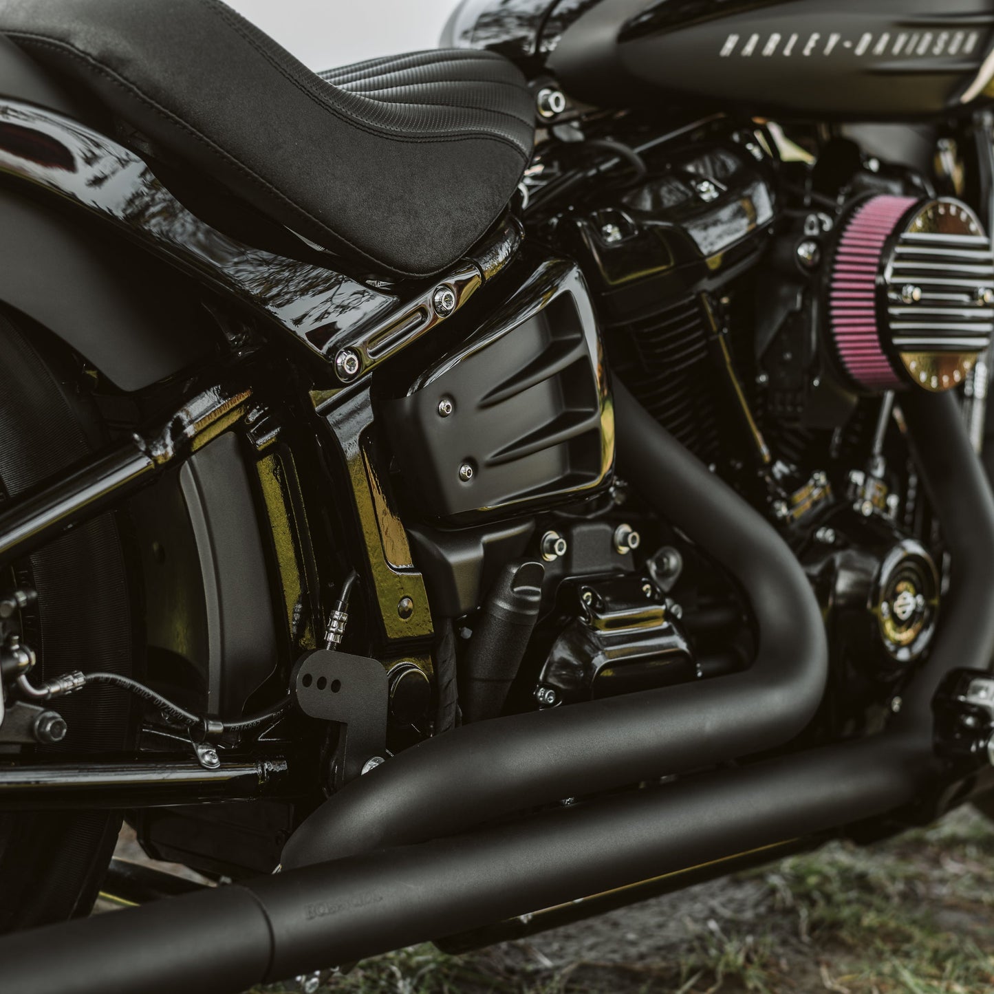Zoomed Harley Davidson motorcycle with Killer Custom "Avenger" shock absorber adjustment knob from the side