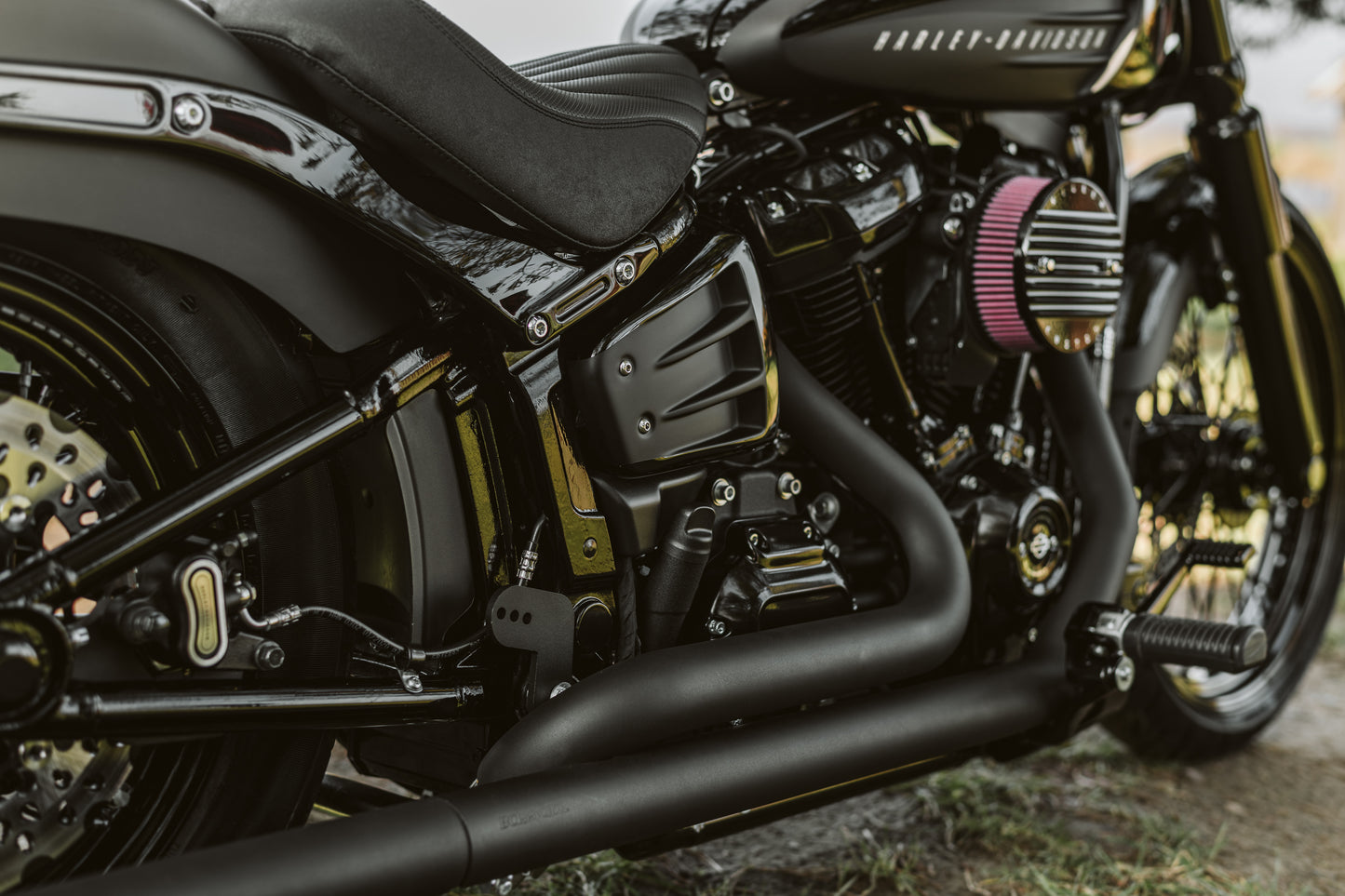 Zoomed Harley Davidson motorcycle with Killer Custom "Avenger" shock absorber adjustment knob from the side