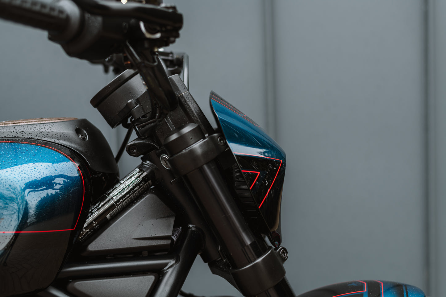 Zoomed Harley Davidson motorcycle with Killer Custom headlight fairing mask form the side grey background