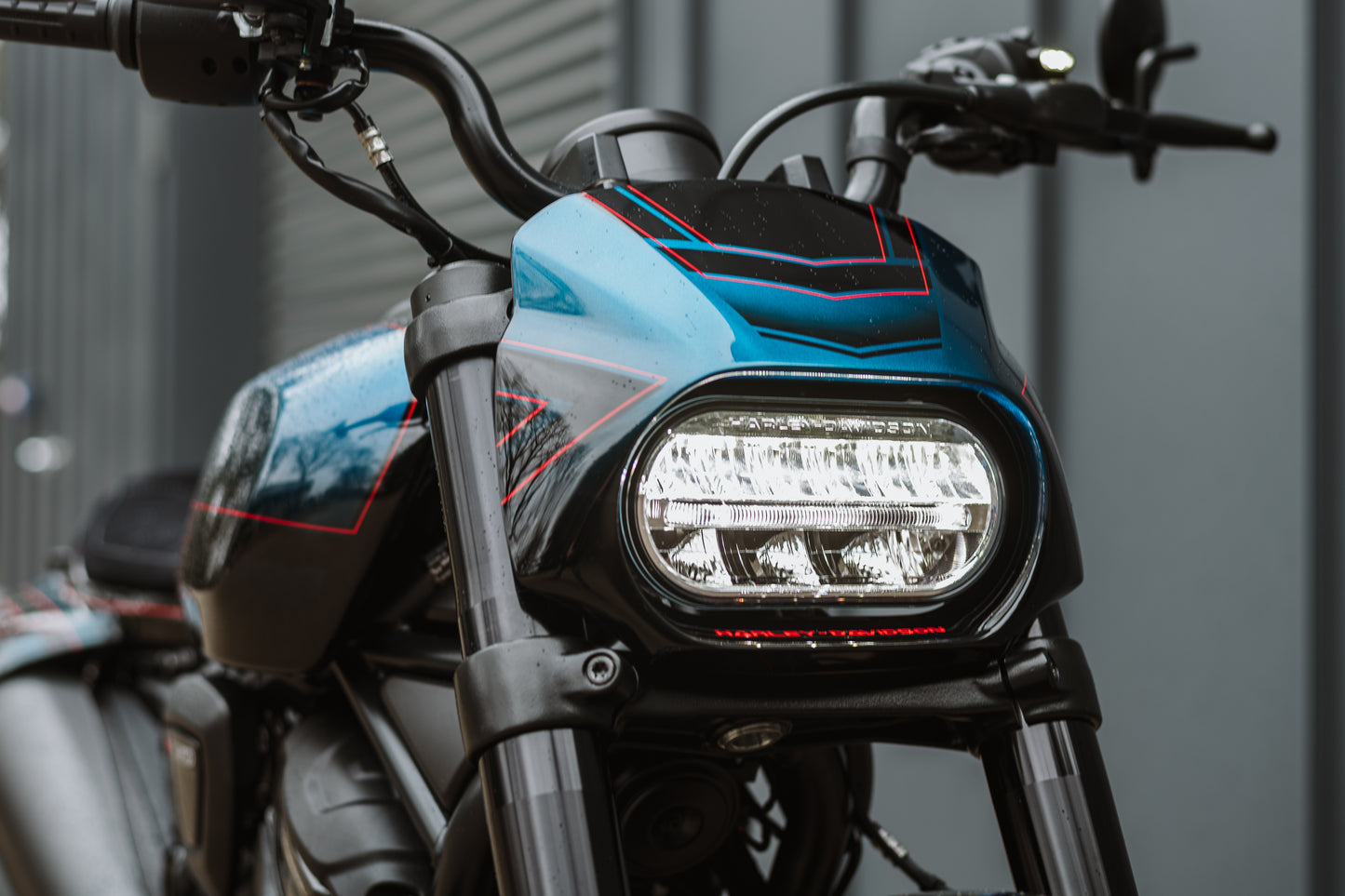 Zoomed Harley Davidson motorcycle with Killer Custom headlight fairing mask form the front grey background
