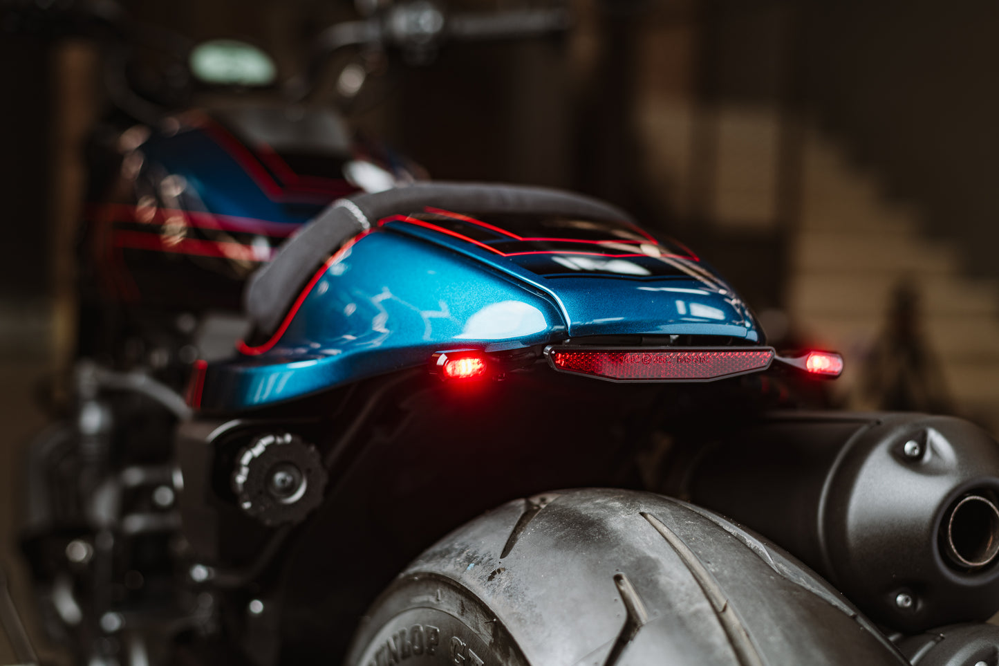Zoomed Harley Davidson motorcycle with Killer Custom LED taillight/turn signal combo from the rear blurry background