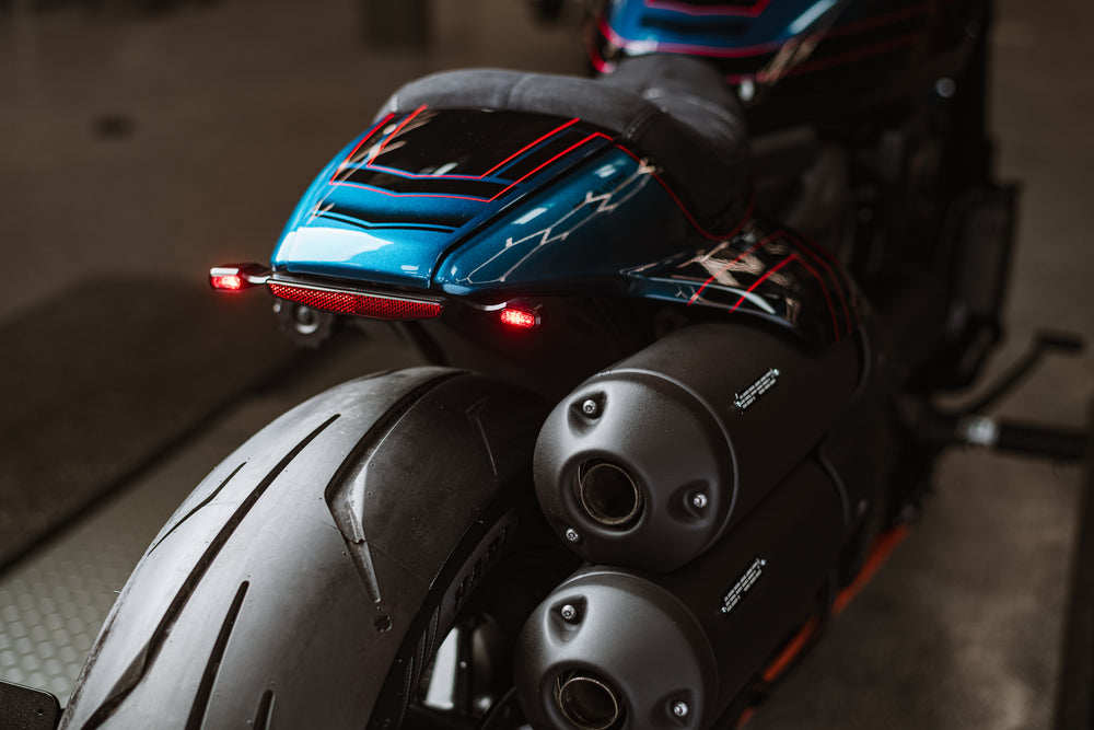 Zoomed Harley Davidson motorcycle with Killer Custom  LED taillight/turn signal combo from the rear blurry background