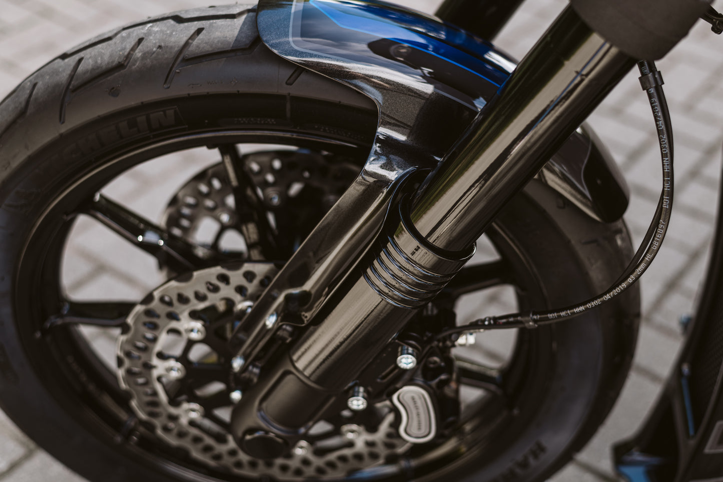 Zoomed Harley Davidson motorcycle with Killer Custom fat bob and low ride lower fork covers