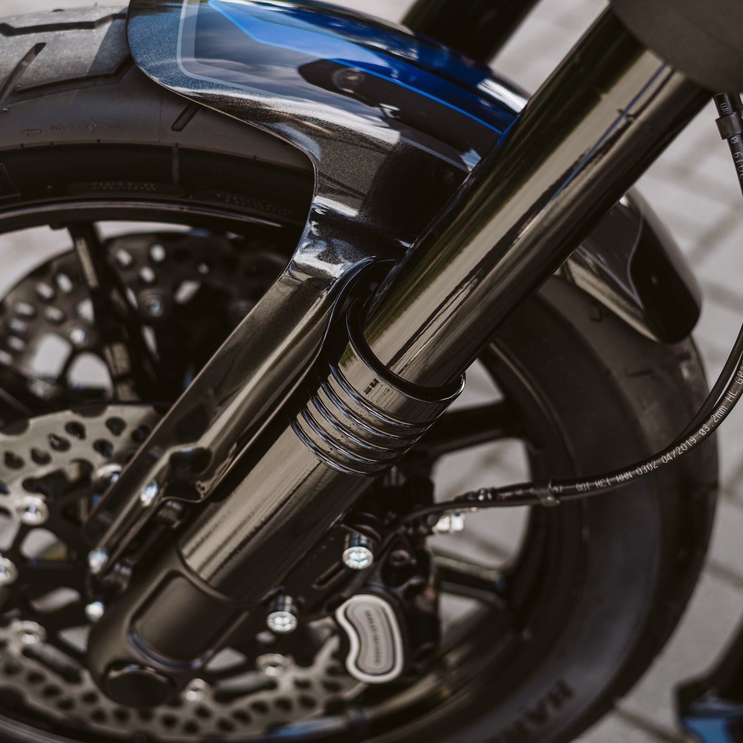 Zoomed Harley Davidson motorcycle with Killer Custom fat bob and low ride lower fork covers