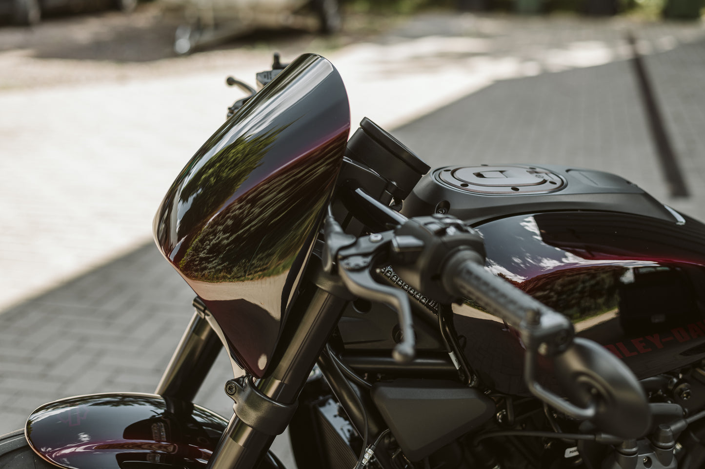 Harley Davidson motorcycle with Killer Custom Harley Davidson "Road Warrior" headlight fairing mask with a blurred pavement