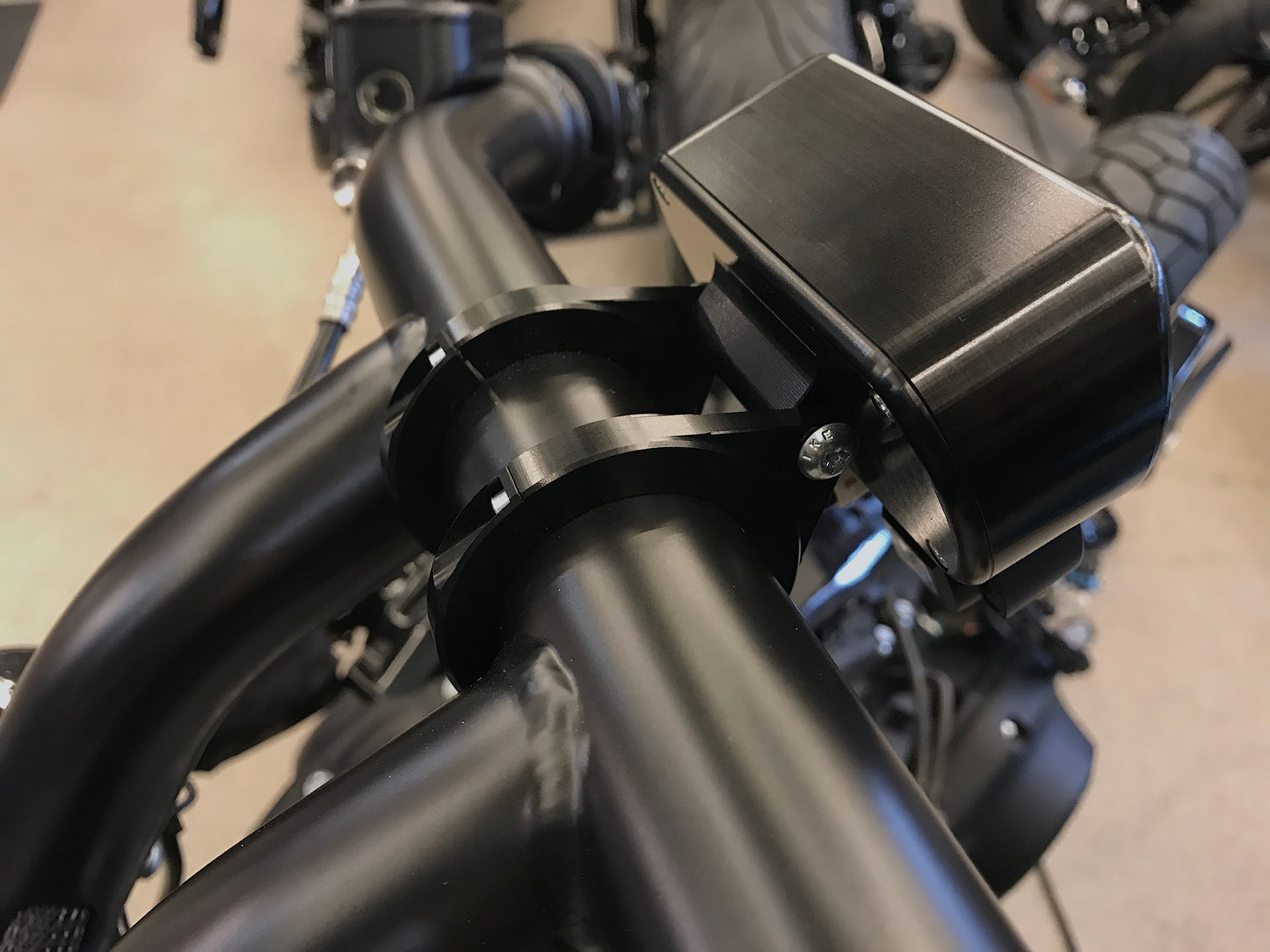 Zoomed Harley Davidson motorcycle with Killer Custom cluster-speedometer relocation housing holders for handlebars