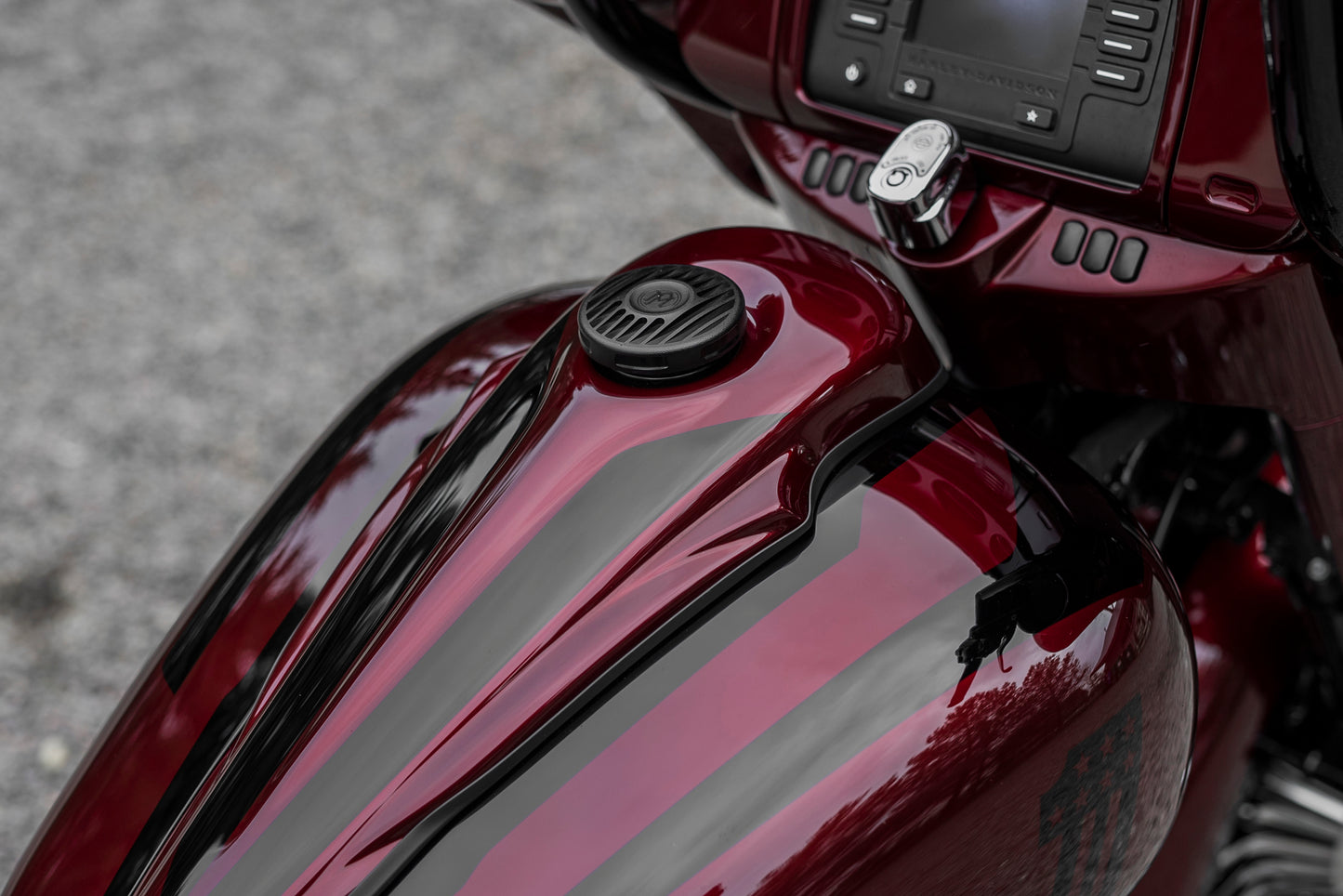 Zoomed Harley Davidson motorcycle with Killer Custom gas tank console from above blurred background