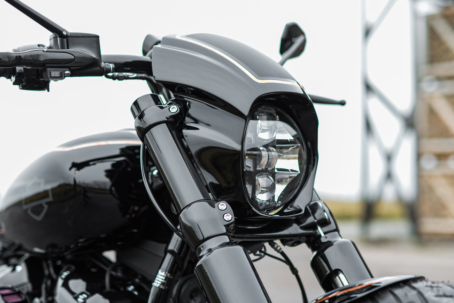 Zoomed Harley Davidson motorcycle with Killer Custom "Aggressor" headlight fairing from the front blurry background