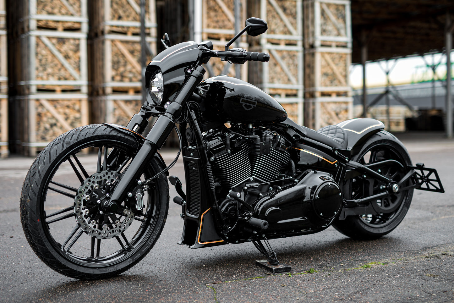 Harley Davidson motorcycle with Killer Custom "Aggressor" full fork cover set from the side in an industrial environment