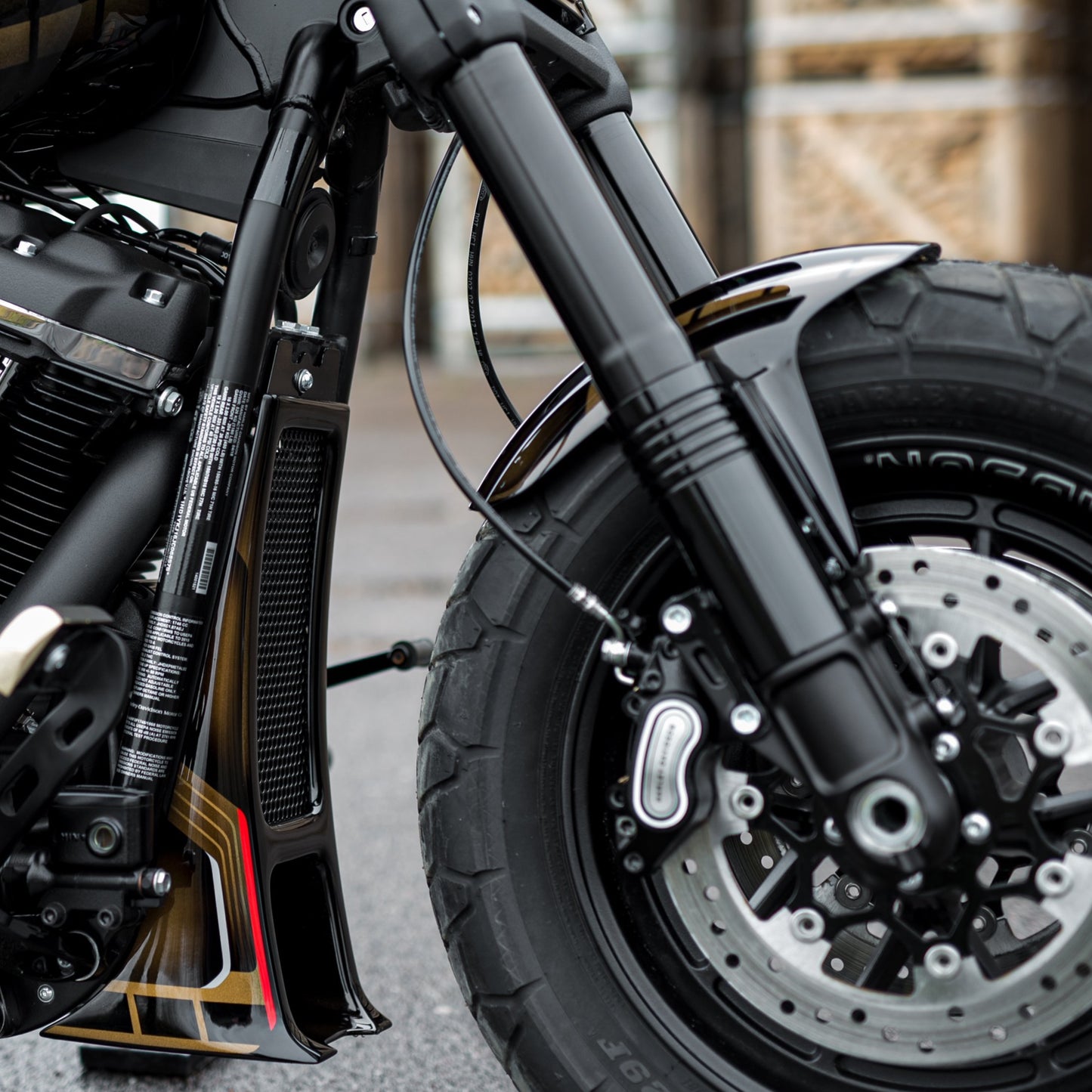 Zoomed Harley Davidson  motorcycle with Killer Custom rear fender in an industrial environment