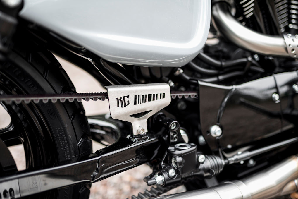 Zoomed Harley Davidson motorcycle with Killer Custom belt cover from the side