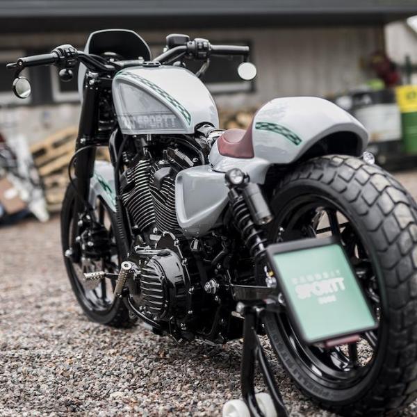 Harley Davidson motorcycle with Killer Custom sportster gas tank cover from the rear outside with industrial equipment in the background