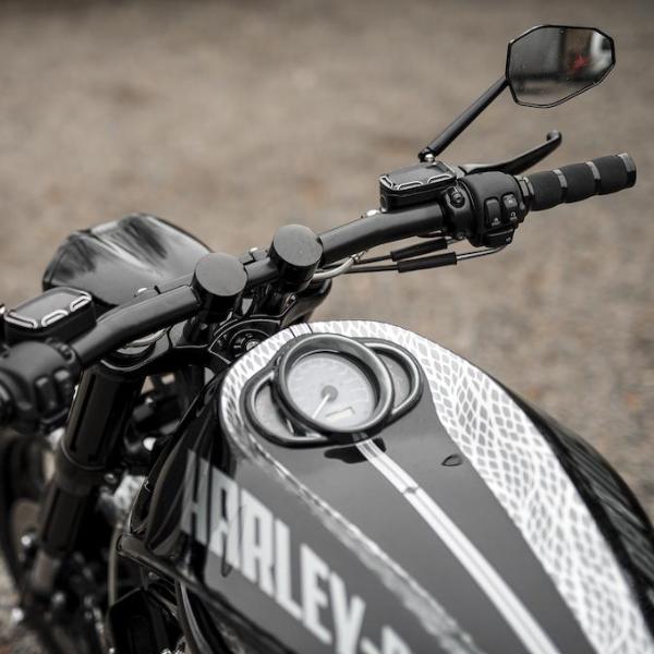 Zoomed Harley Davidson motorcycle with Killer Custom handlebar riser kit from above neutral blurry background