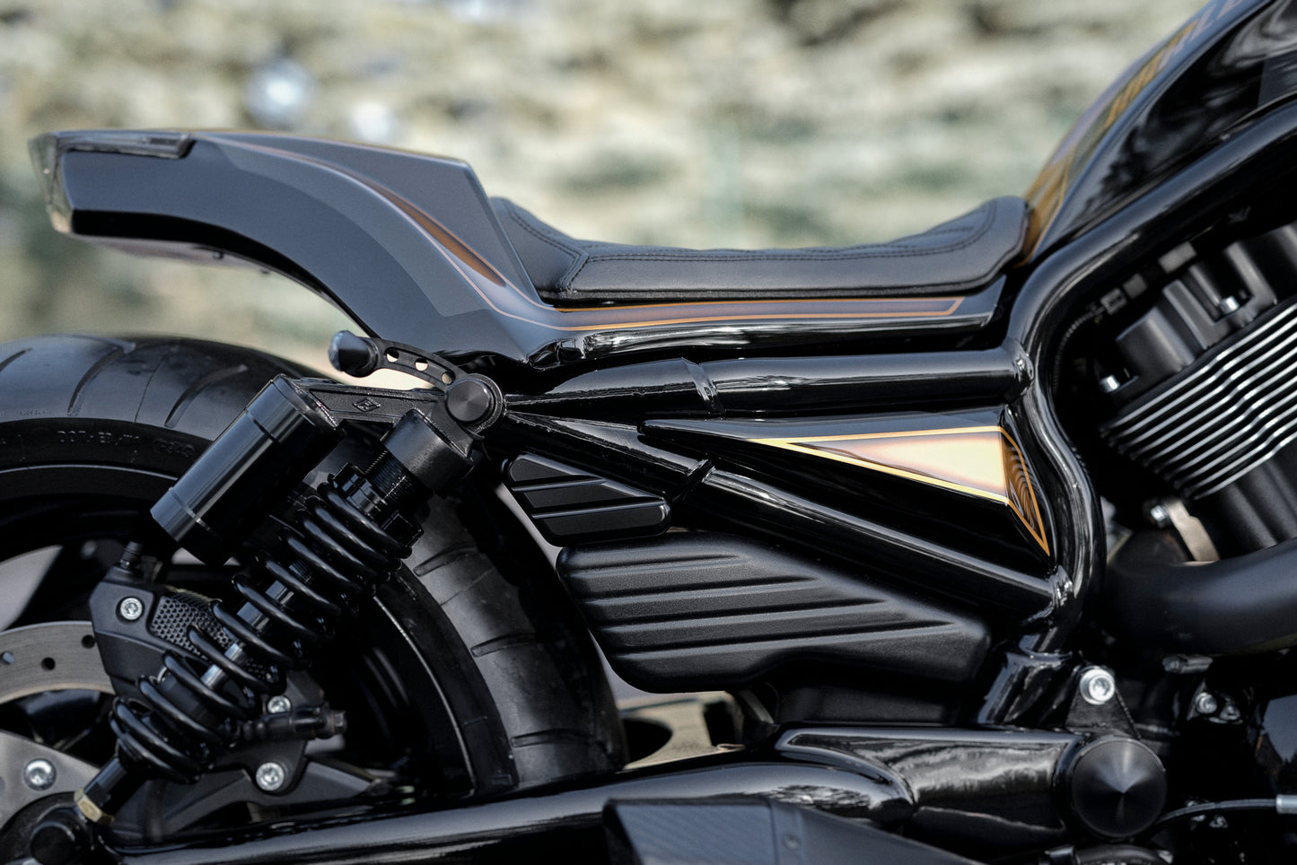 Zoomed Harley Davidson motorcycle with Killer Custom V-Rod billet turn signal bracket from the side blurry background
