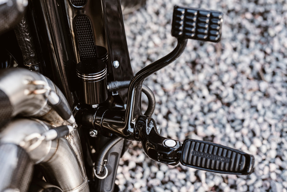 Zoomed Harley Davidson motorcycle with Killer Custom V-Rod master brake reservoir relocation kit blurry background