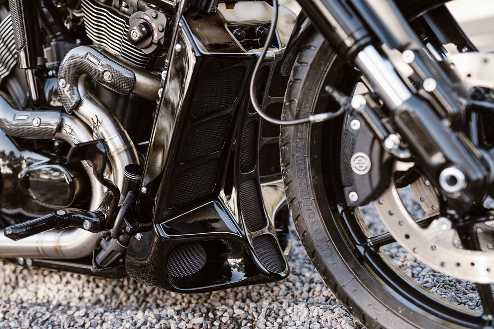 Zoomed Harley Davidson motorcycle with Killer Custom V-Rod master brake reservoir relocation kit blurry background
