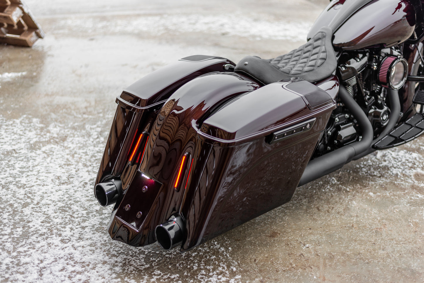 Zoomed Harley Davidson motorcycle with Killer Custom extended bagger saddlebags from the rear neutral background
