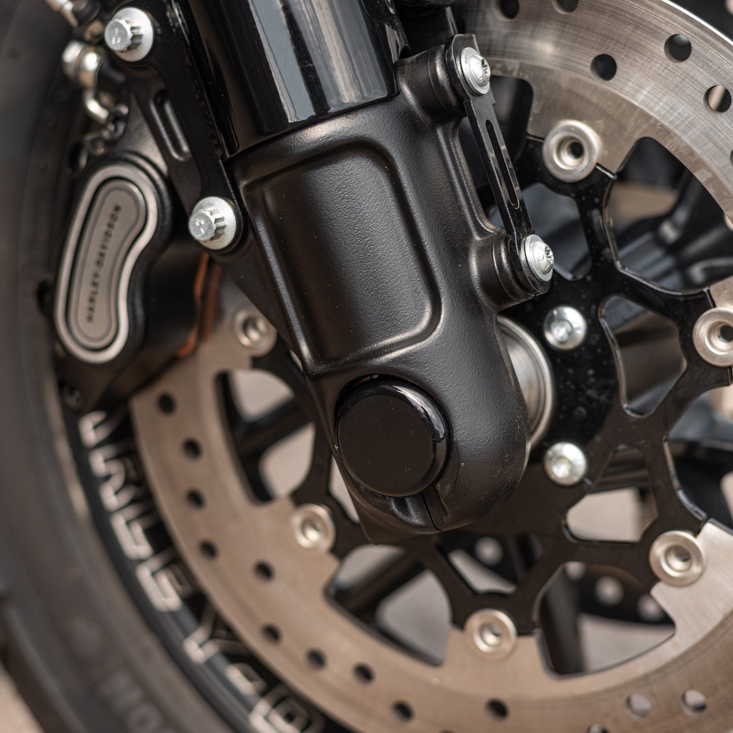 Zoomed Harley Davidson motorcycle with Killer Custom  front axle cover set for fork assemblies