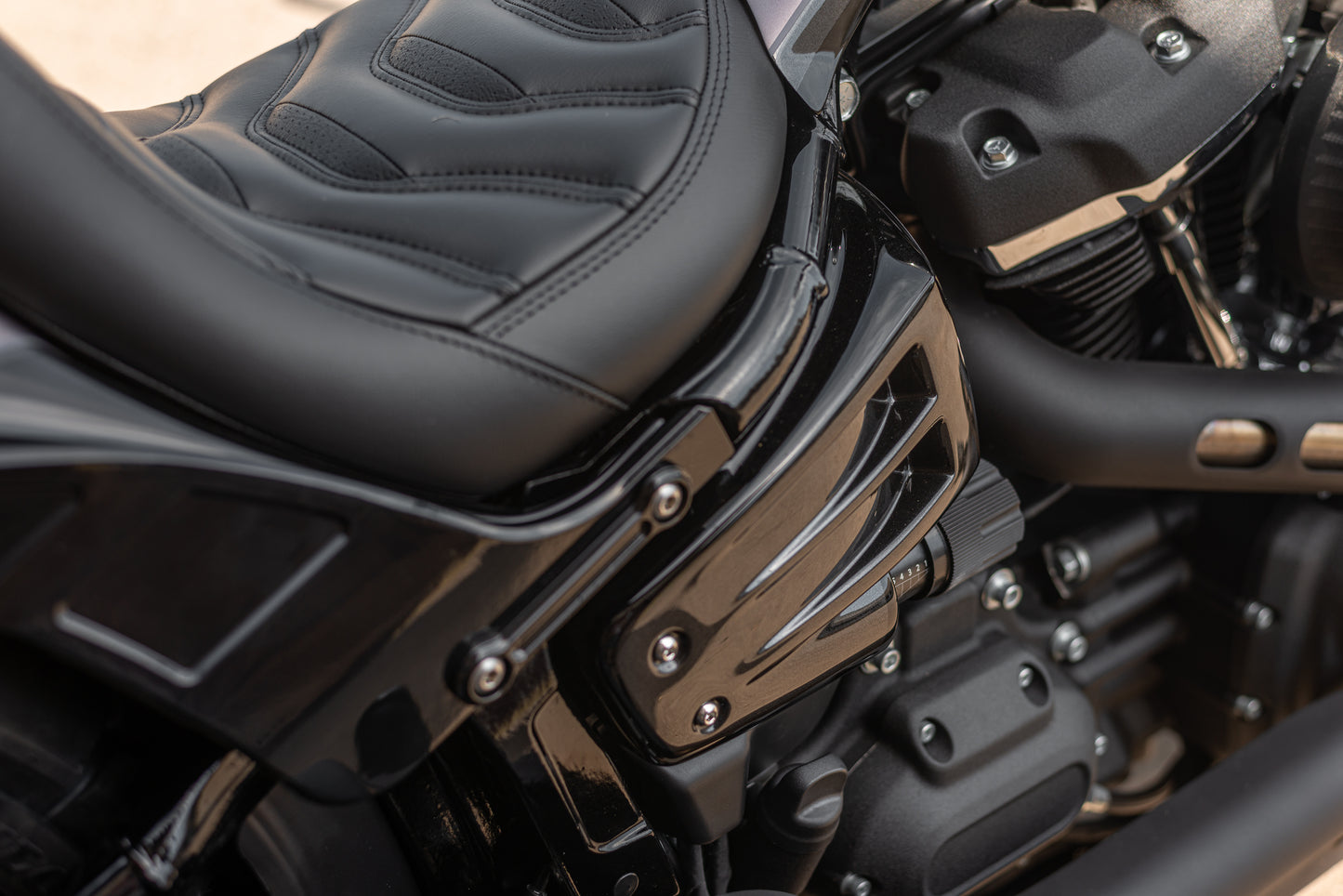 Zoomed Harley Davidson motorcycle with "Avenger" side covers from the side