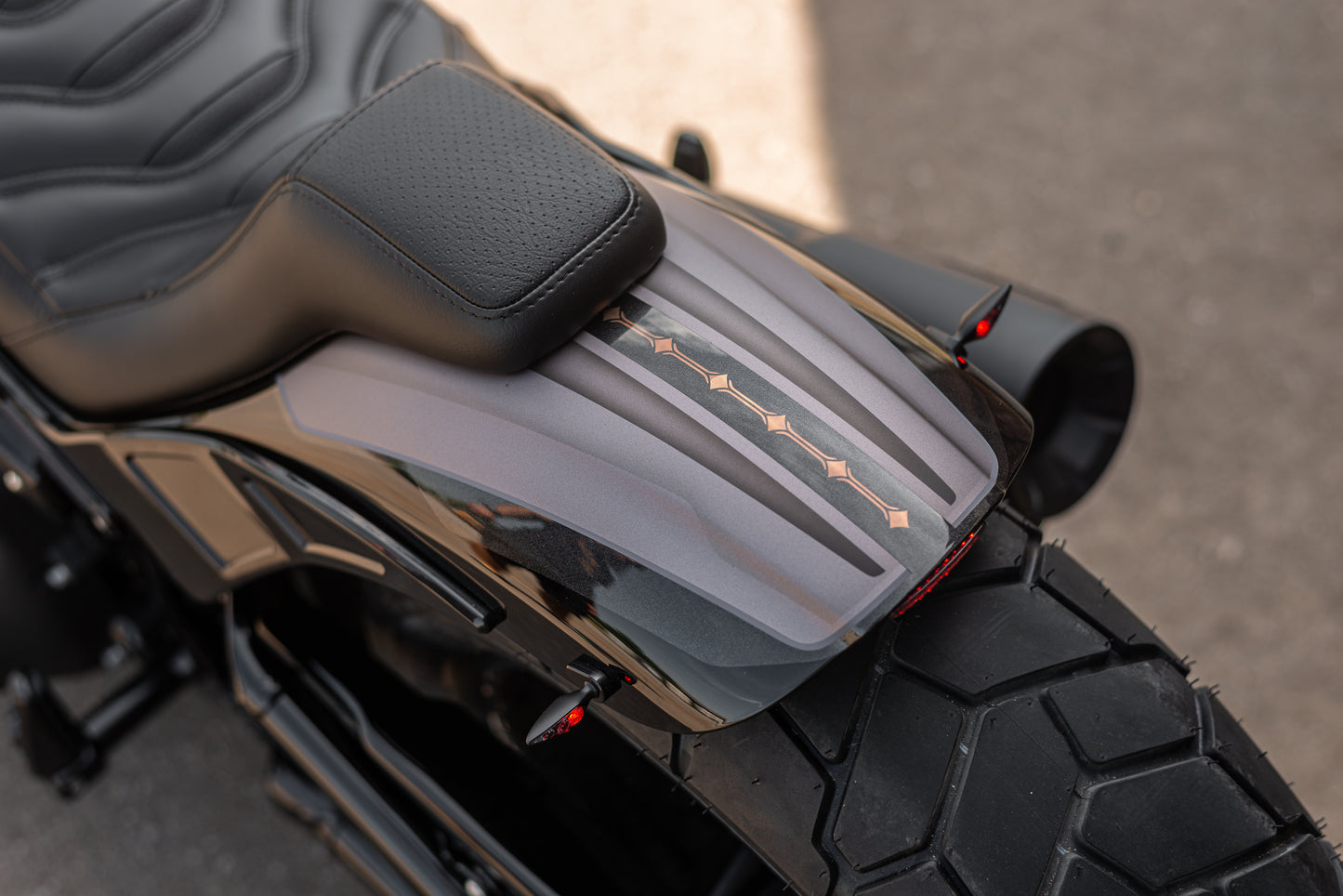 Zoomed Harley Davidson motorcycle with Killer Custom "Bobbstr" rear fender neutral background