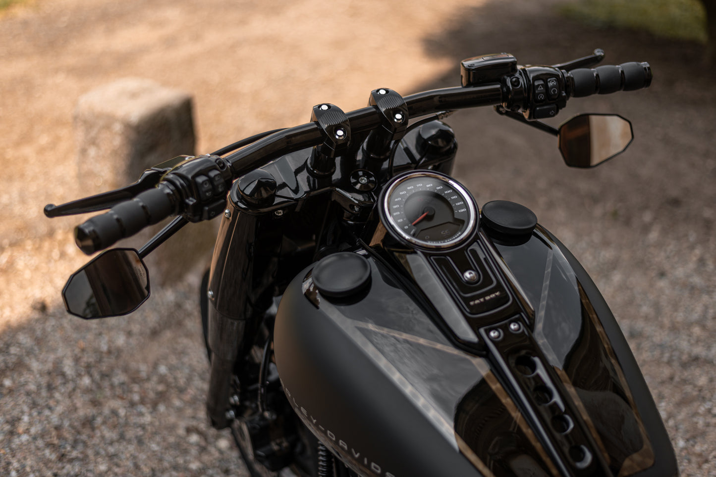 Zoomed Harley Davidson motorcycle with Killer Custom  "Avenger" fat drag handlebar from above blurry background