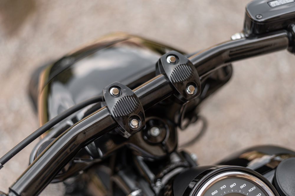 Zoomed Harley Davidson motorcycle with Killer Custom riser set for handlebar from above blurry background