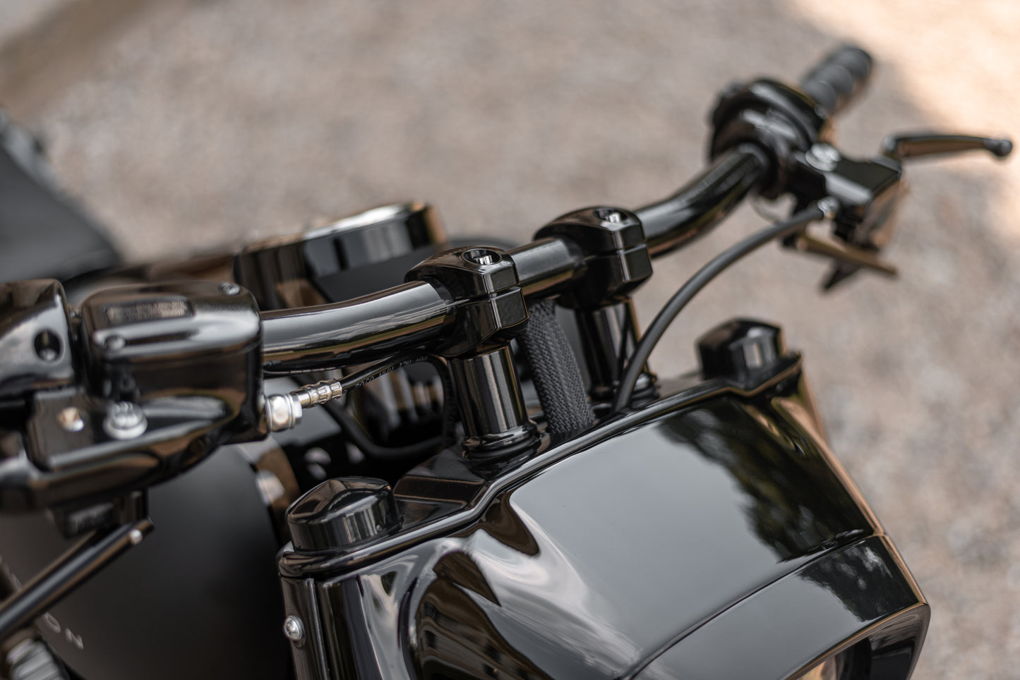 Zoomed Harley Davidson motorcycle with Killer Custom "Avenger" fat drag handlebar from above blurry background