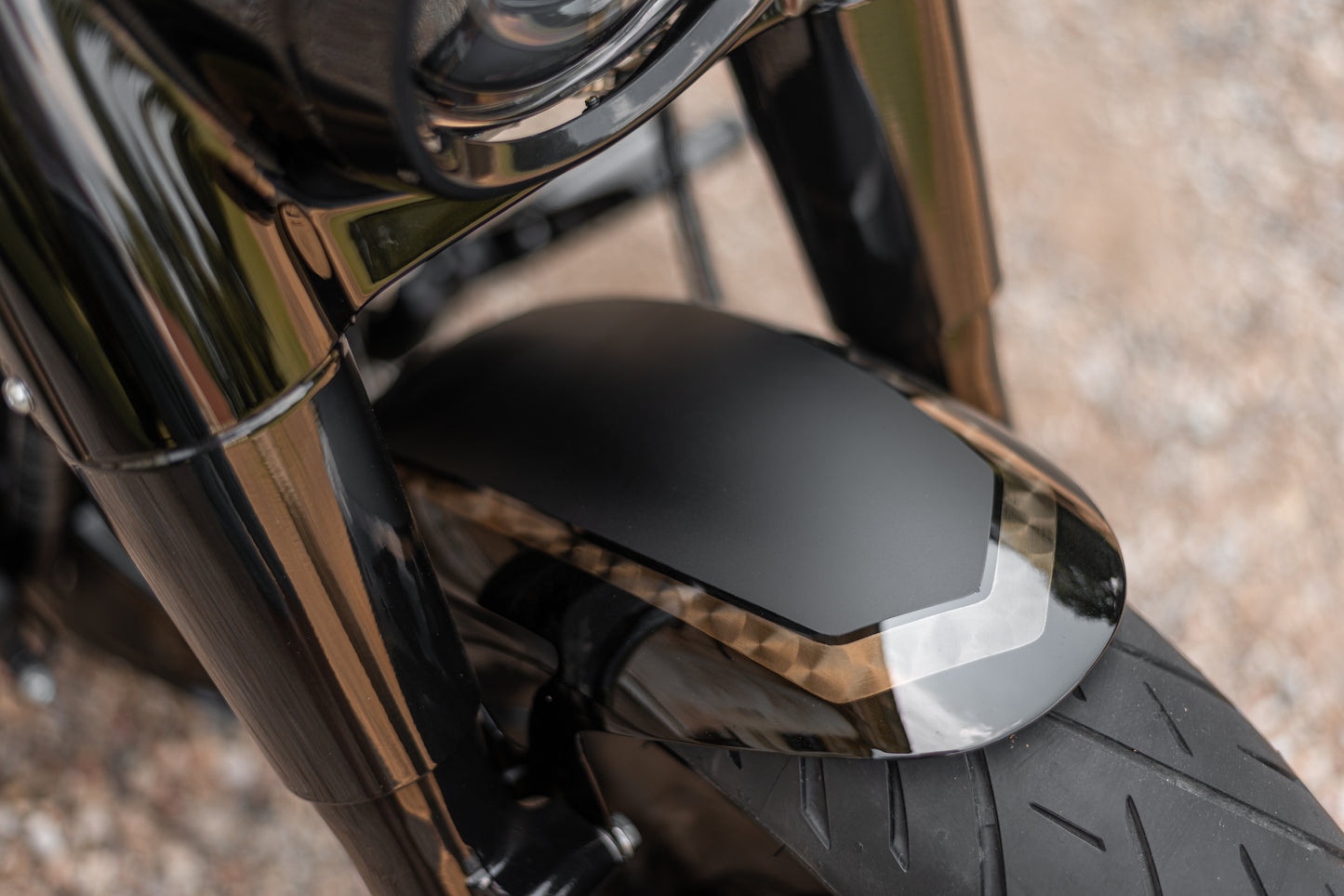 Zoomed Harley Davidson motorcycle with Killer Custom parts blurred background