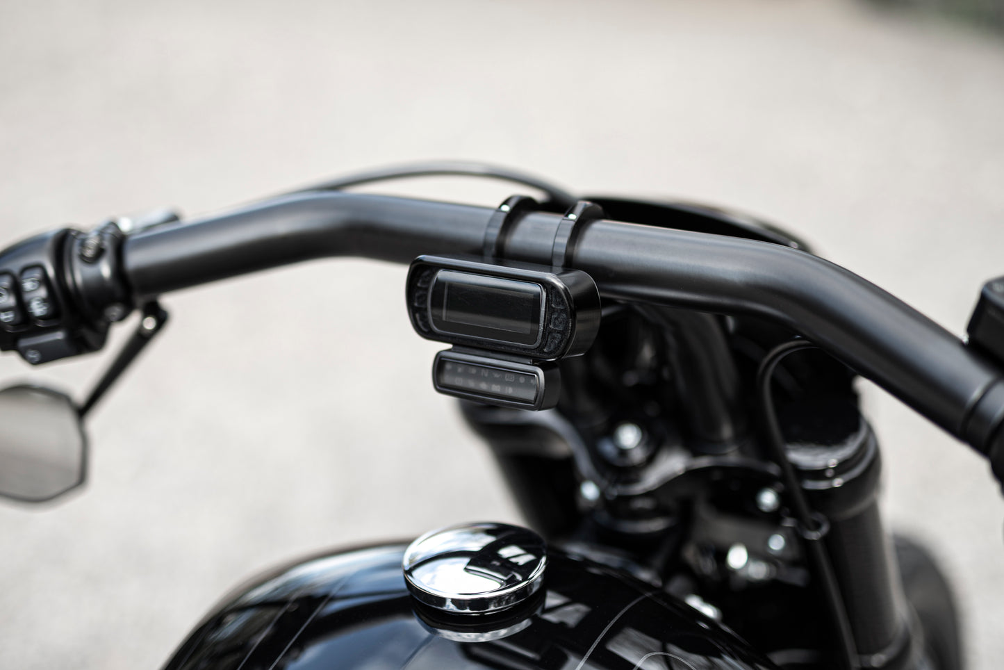 Zoomed Harley Davidson motorcycle with Killer Custom cluster-speedometer relocating housing from above neutral background