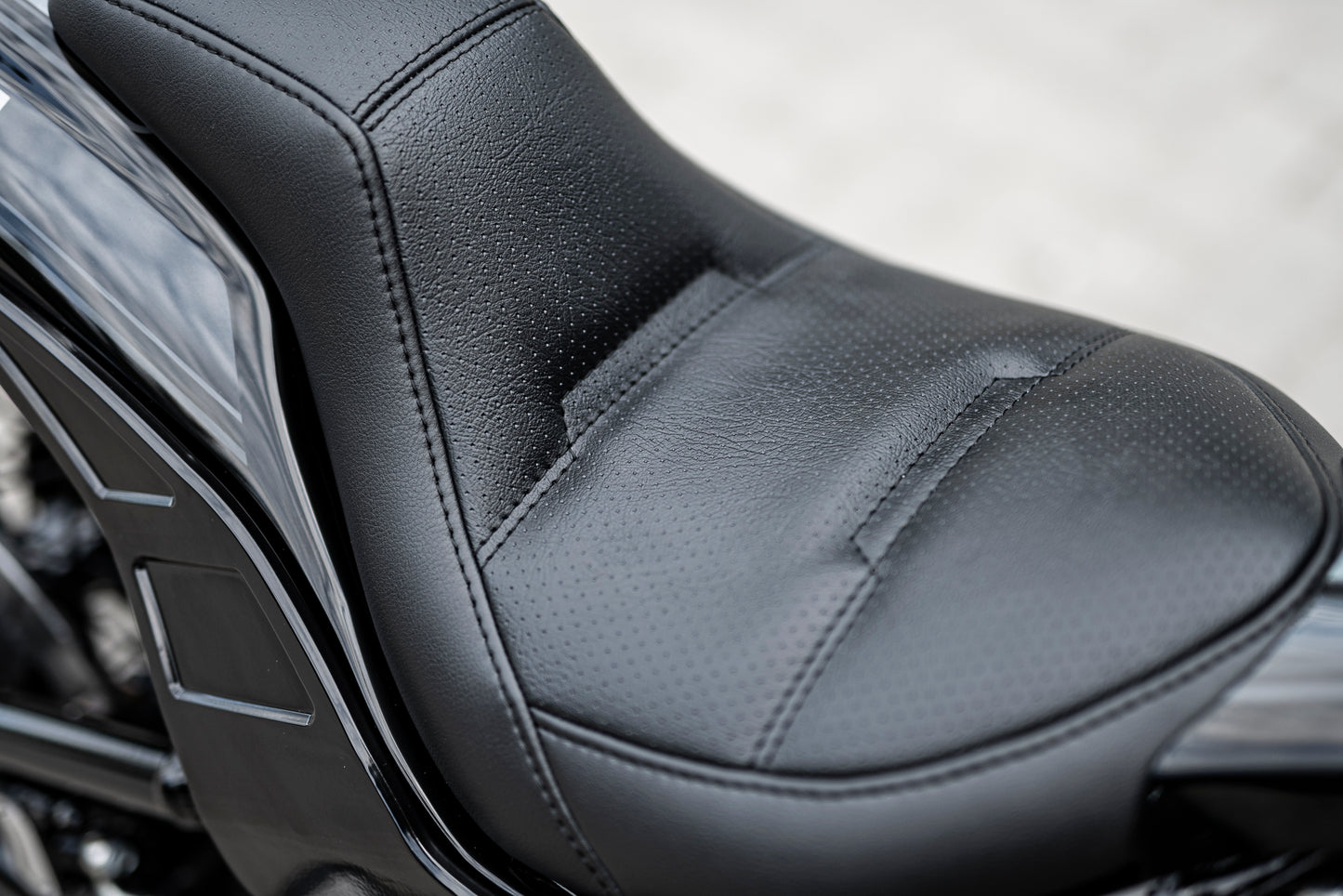 Zoomed Harley Davidson motorcycle with Killer Custom seat for rear fenders white background