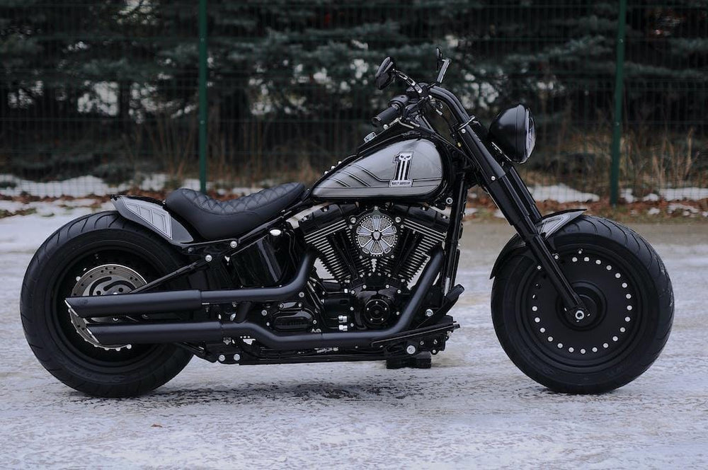  Harley Davidson motorcycle with Killer Custom parts from the side outside with some visible snow and trees in the background