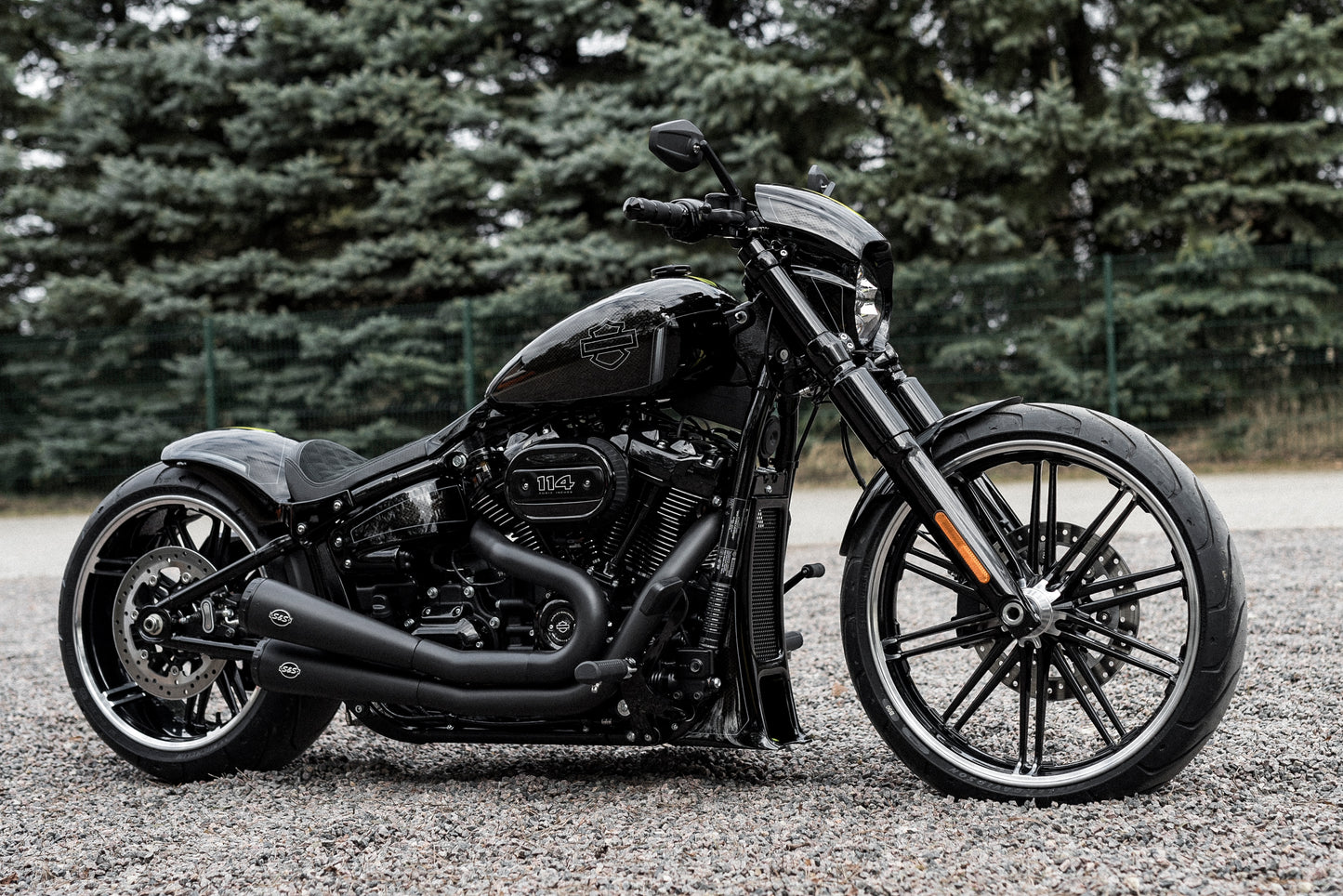 Harley Davidson motorcycle with Killer Custom front fender from the side in a nature environment