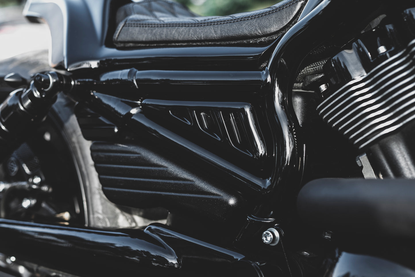 Zoomed Harley Davidson motorcycle with Killer Custom V-Rod "Mustang" tank frame side covers from the side