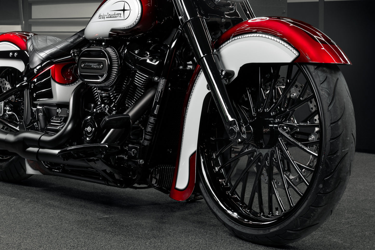 Harley Davidson motorcycle with Killer Custom "Hot rod series" front fender from the front in an industrial environment