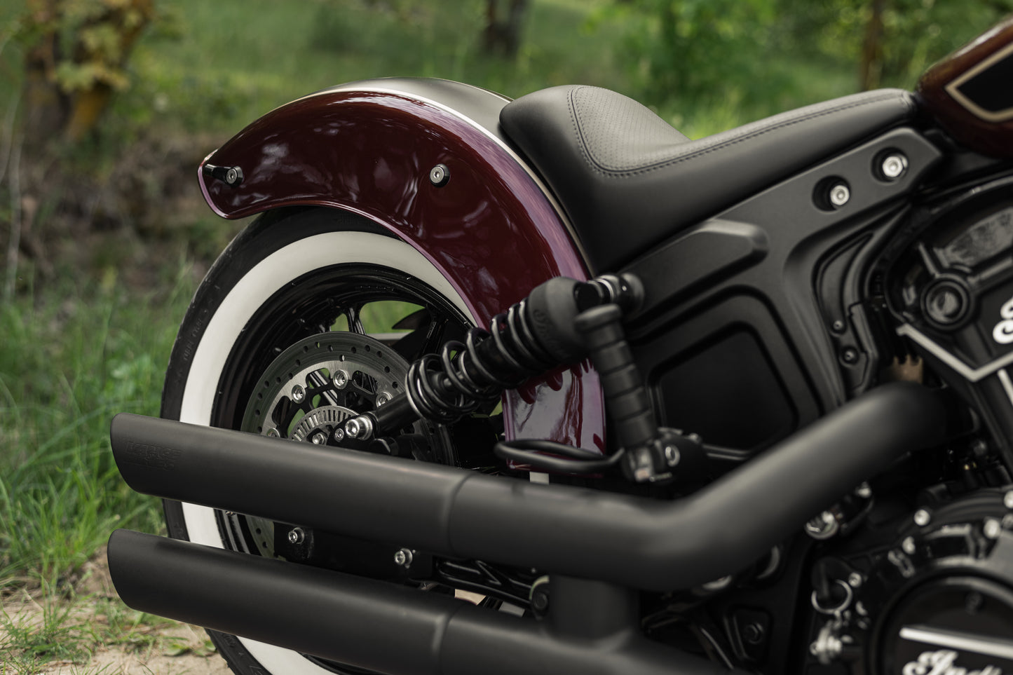 Harley Davidson motorcycle with Killer Custom "Apache" rear fender from the side in the forest