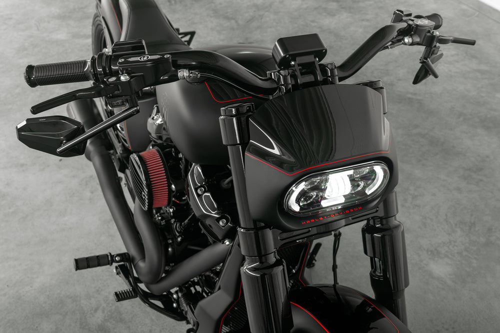 Harley Davidson motorcycle with Killer Custom wide triple trees set from the front grey background