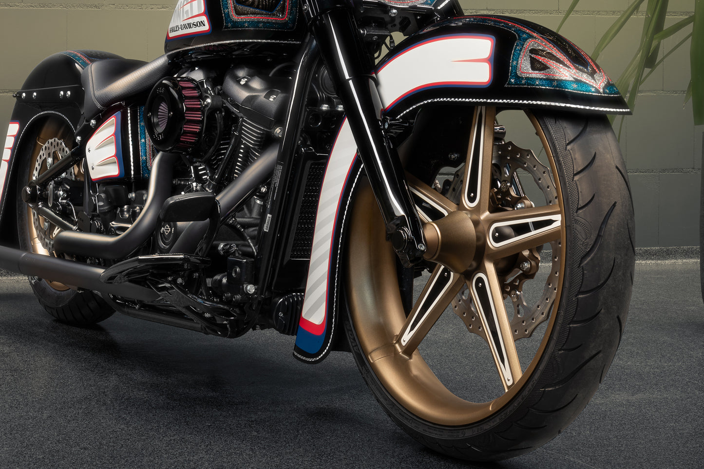 Harley Davidson motorcycle with Killer Custom "Hot rod series" front fender from the front in an industrial environment