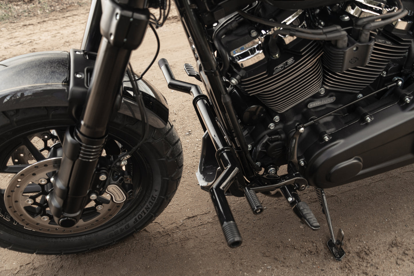 Zoomed Harley Davidson motorcycle with Killer Custom "Task Force" softail M8 crash bar on a roadside