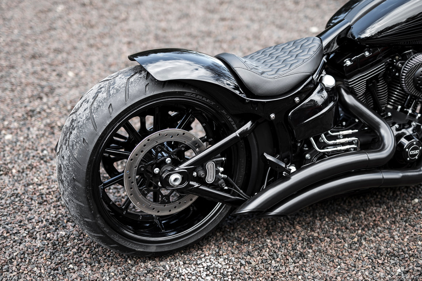 Harley Davidson motorcycle with Killer Custom  "Competition Series" front wrap fender from the side blurry background