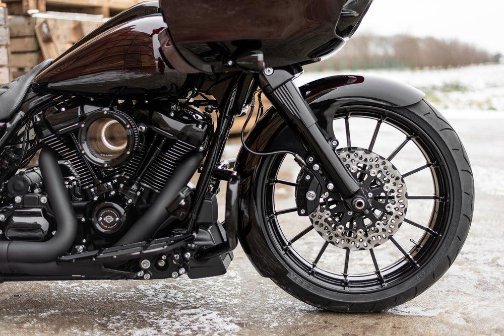 Harley Davidson motorcycle with Killer Custom front fender from the side outside with visible snow in the background
