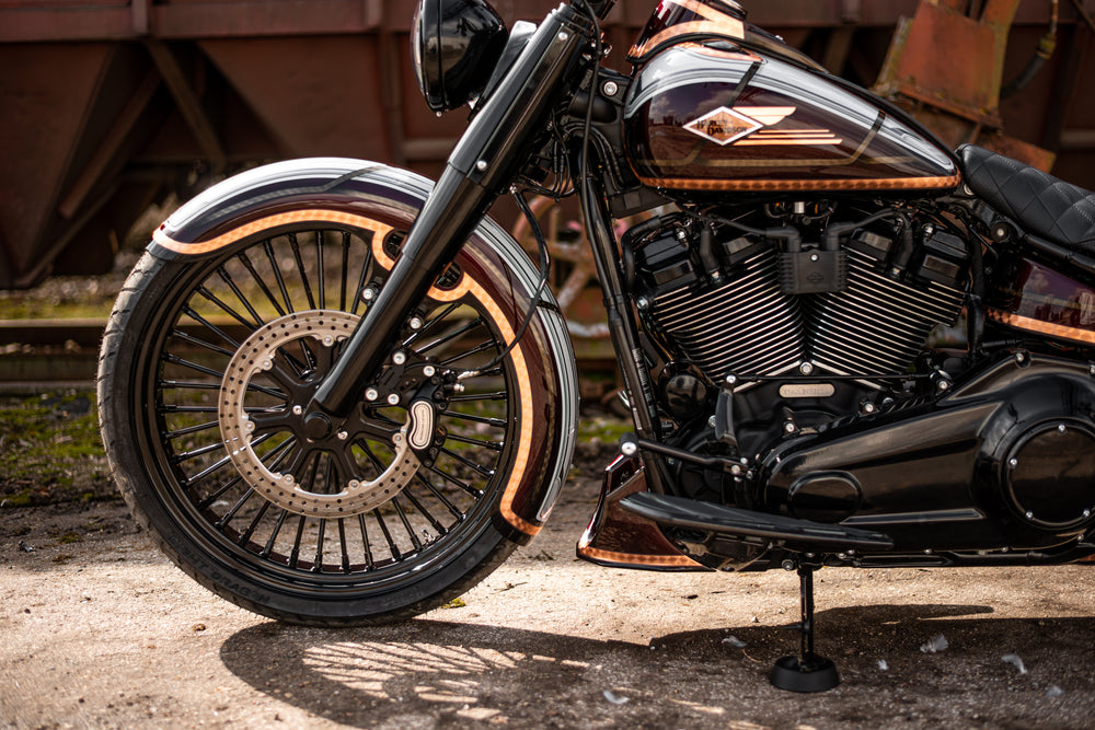 Harley Davidson motorcycle with Killer Custom front wrap fender outside on a sunny day in an industrial environment
